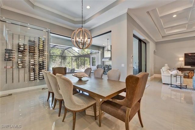 tiled dining area with an inviting chandelier, a tray ceiling, and ornamental molding