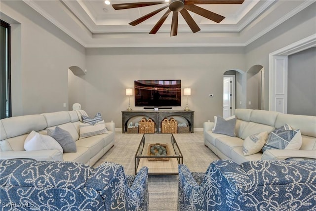 living room with ceiling fan and ornamental molding