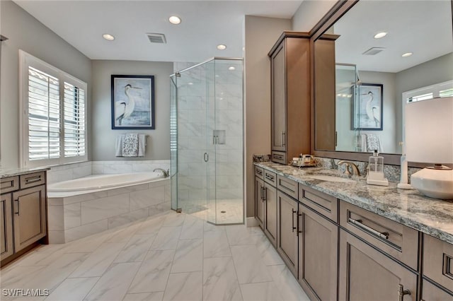 bathroom with independent shower and bath and vanity