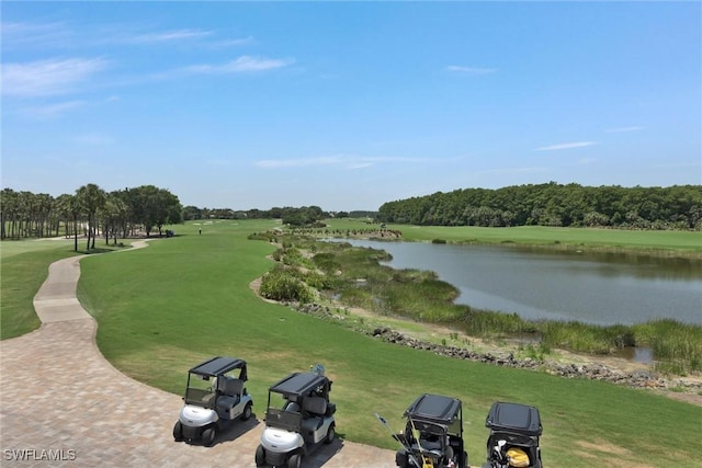 exterior space with a water view and a lawn