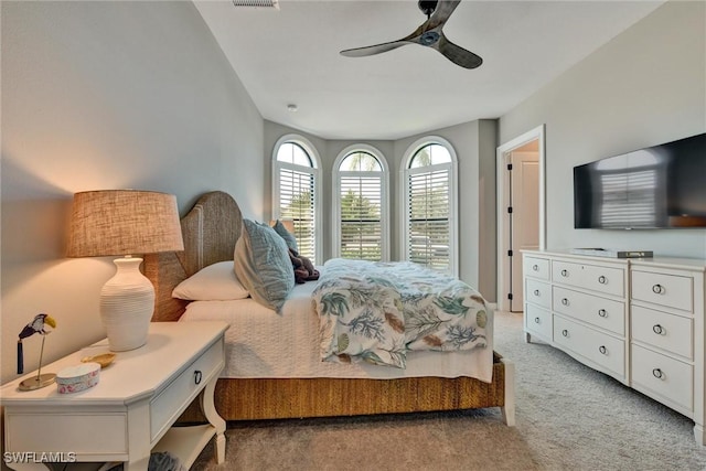 bedroom with light carpet and ceiling fan