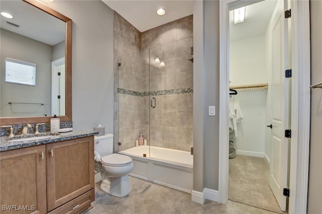 full bathroom featuring toilet, enclosed tub / shower combo, and vanity