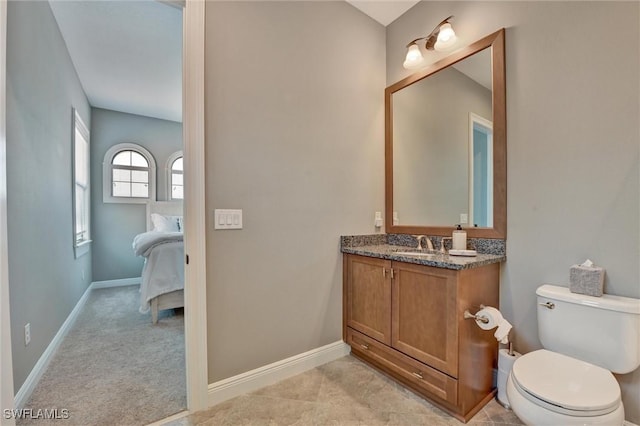 bathroom with toilet and vanity