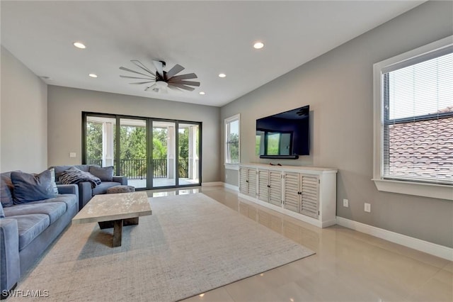 living room with ceiling fan and light tile patterned floors