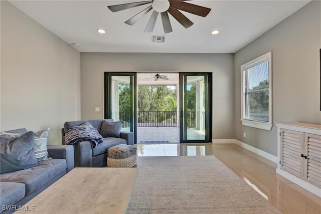 living room featuring ceiling fan and light wood-type flooring