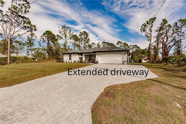 view of front of home with a front lawn and a garage