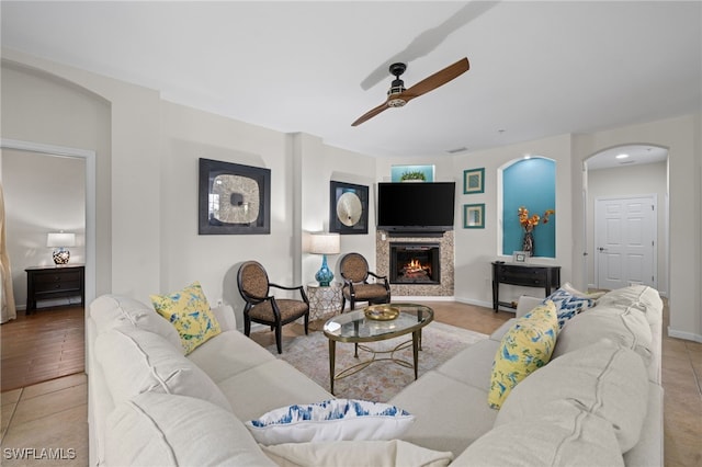 tiled living room featuring ceiling fan