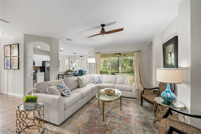 tiled living room featuring ceiling fan