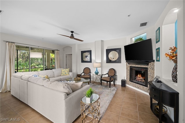 living room with ceiling fan and tile patterned floors