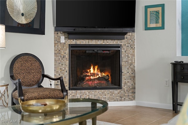 sitting room with light tile patterned floors and a tile fireplace