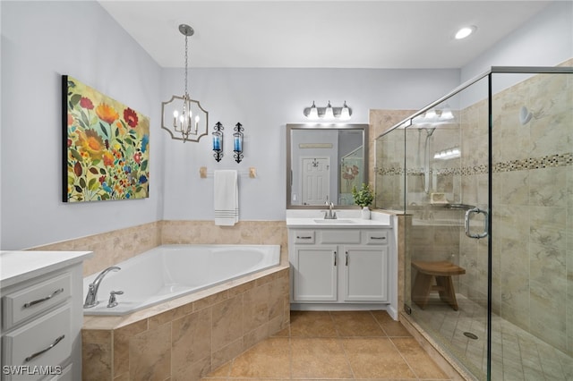 bathroom featuring tile patterned flooring, a chandelier, separate shower and tub, and vanity