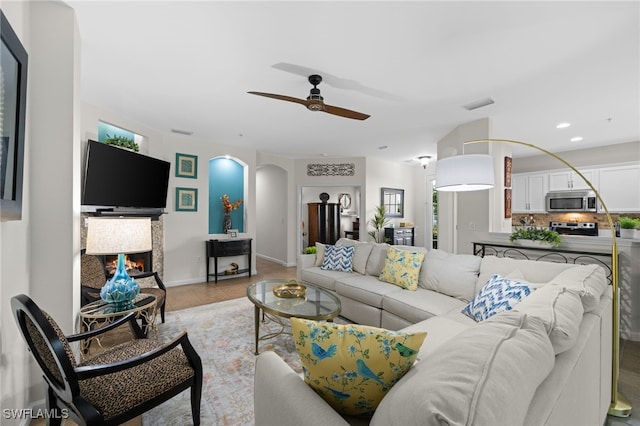 tiled living room featuring ceiling fan