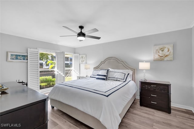 bedroom with ornamental molding, ceiling fan, and light hardwood / wood-style floors