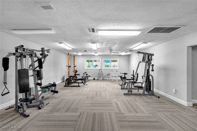 exercise room featuring a textured ceiling