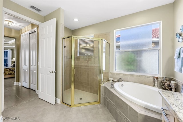 bathroom with tile patterned floors, vanity, and independent shower and bath