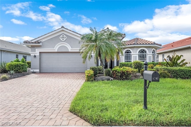 view of front of property with a garage and a front lawn