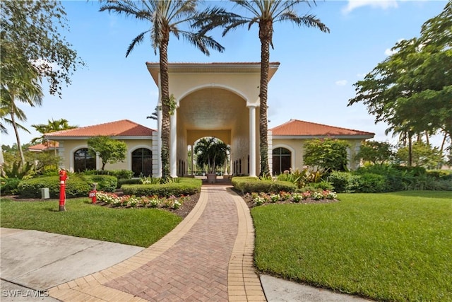 mediterranean / spanish-style home with a front yard