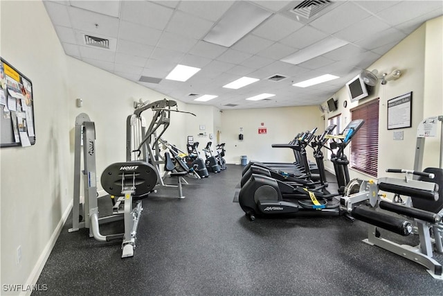 gym with a paneled ceiling