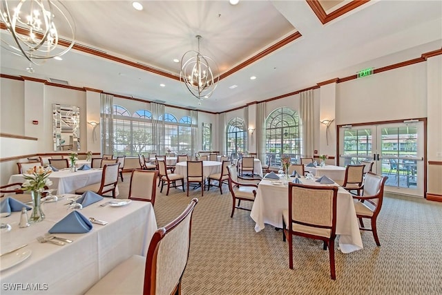 dining room with french doors, ornamental molding, a tray ceiling, a notable chandelier, and light colored carpet