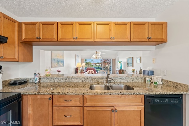 kitchen featuring light stone counters, sink, a textured ceiling, and black appliances