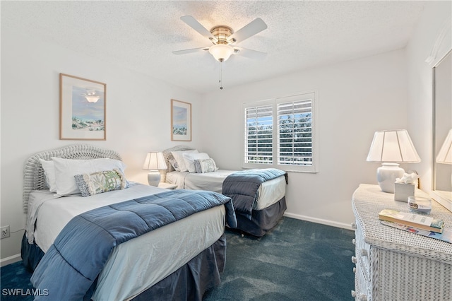 carpeted bedroom featuring ceiling fan and a textured ceiling