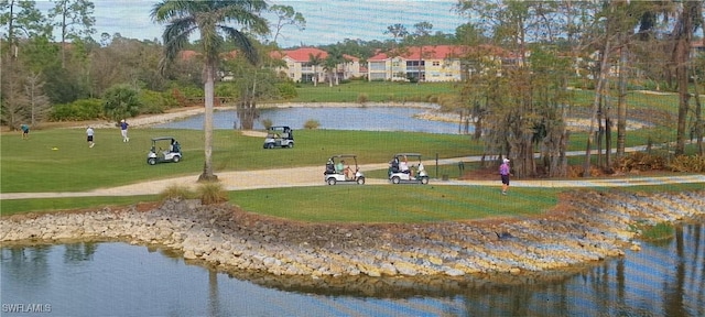 surrounding community with a yard and a water view