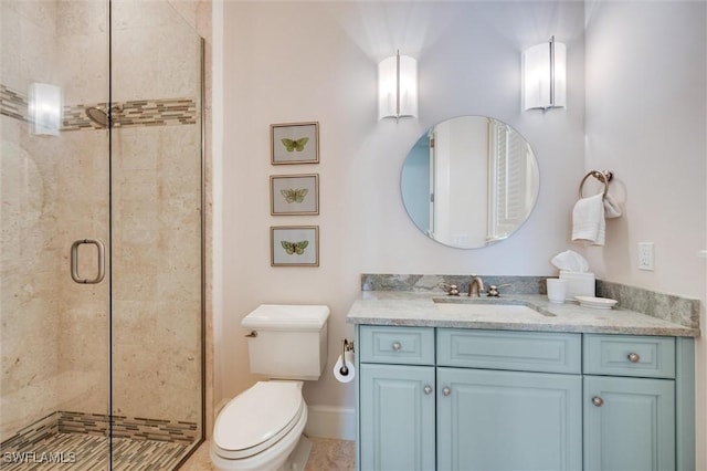 bathroom with vanity, toilet, and walk in shower