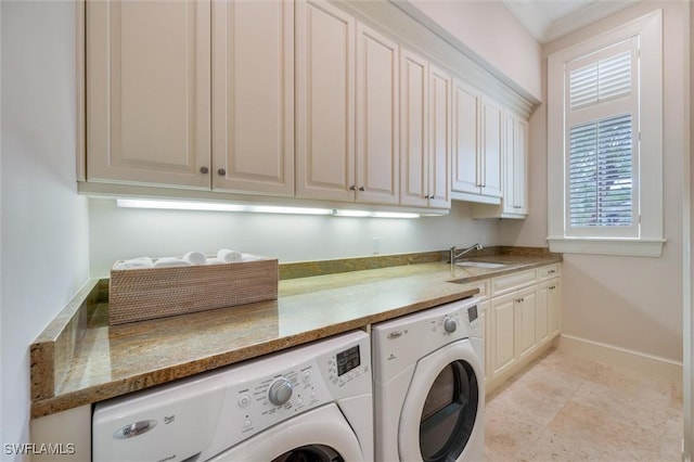 washroom featuring cabinets, sink, and washing machine and clothes dryer