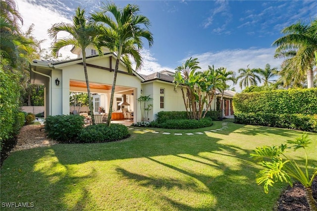 rear view of house with a yard