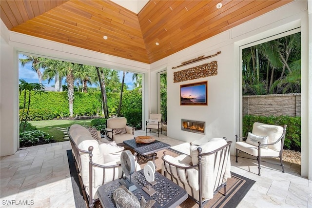 sunroom with wood ceiling and vaulted ceiling