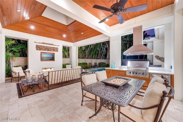 view of patio featuring ceiling fan, an outdoor fire pit, exterior kitchen, and a grill