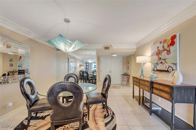 dining room with light tile patterned floors and ornamental molding