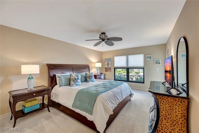 bedroom with light carpet and ceiling fan