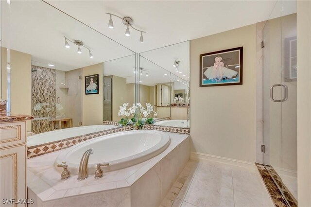 bathroom featuring vanity, tile patterned floors, and separate shower and tub