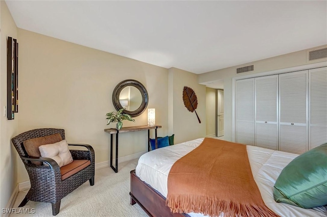 bedroom featuring a closet and light carpet