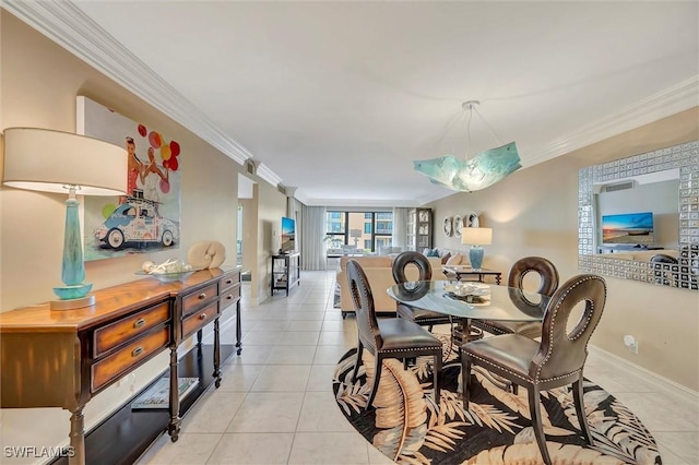 dining room with ornamental molding and light tile patterned floors