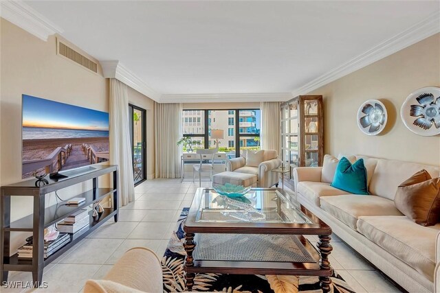 living room with ornamental molding and light tile patterned flooring