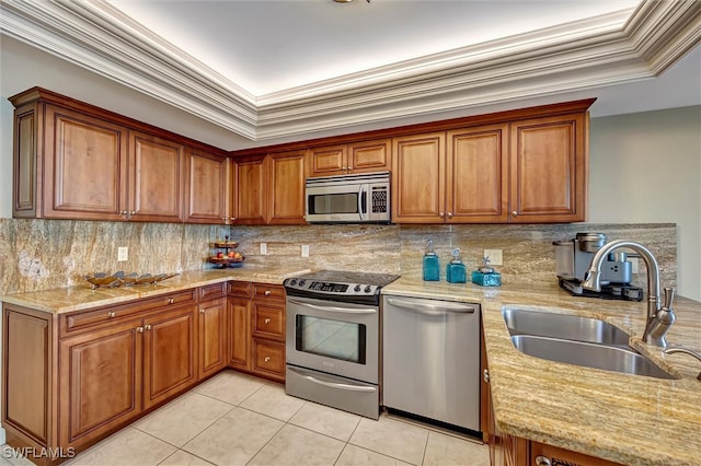 kitchen with sink, light tile patterned floors, appliances with stainless steel finishes, backsplash, and light stone countertops