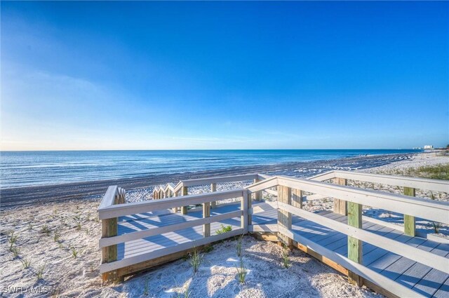 bird's eye view with a water view and a view of the beach