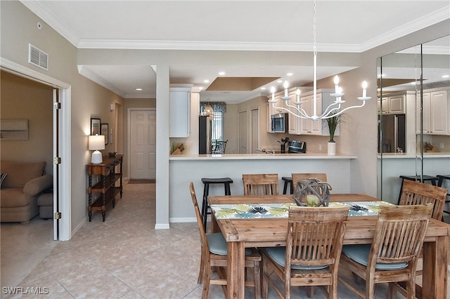 tiled dining room with a notable chandelier and crown molding