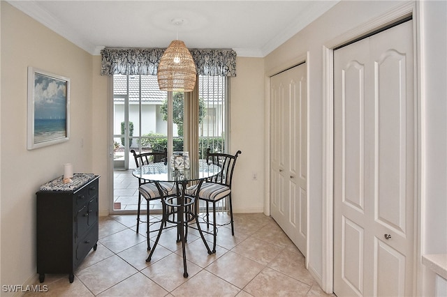 dining room with light tile patterned flooring and ornamental molding