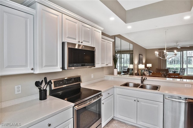 kitchen featuring sink, white cabinetry, stainless steel appliances, and light tile patterned flooring