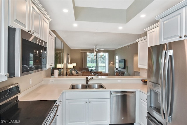 kitchen with white cabinets, appliances with stainless steel finishes, sink, and crown molding