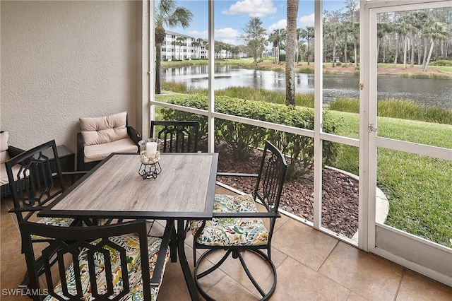 sunroom / solarium featuring a water view