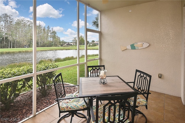 sunroom / solarium with a water view and plenty of natural light