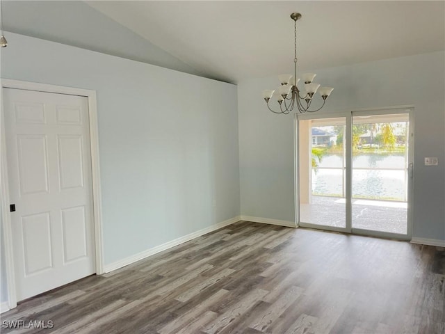 empty room with wood-type flooring, lofted ceiling, and a notable chandelier