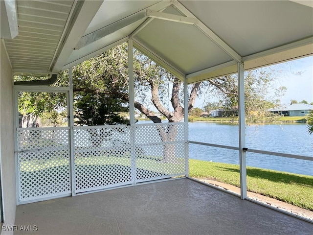 unfurnished sunroom featuring a water view