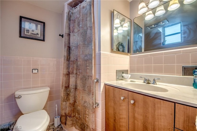 bathroom with tile walls, vanity, toilet, and a shower with shower curtain