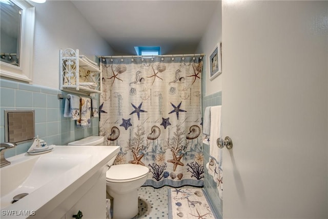 bathroom featuring vanity, tile walls, a shower with shower curtain, and toilet