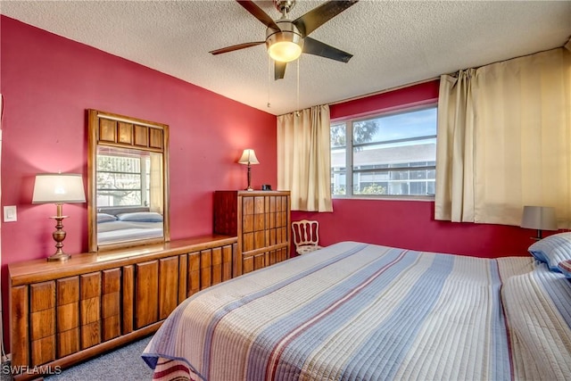 bedroom with carpet floors, a textured ceiling, and ceiling fan